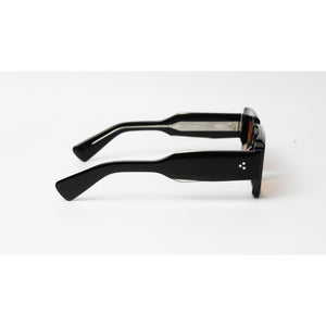 Black square sunglasses with a glossy finish and a small white geometric logo on the temple, shown from a side profile on a white background.