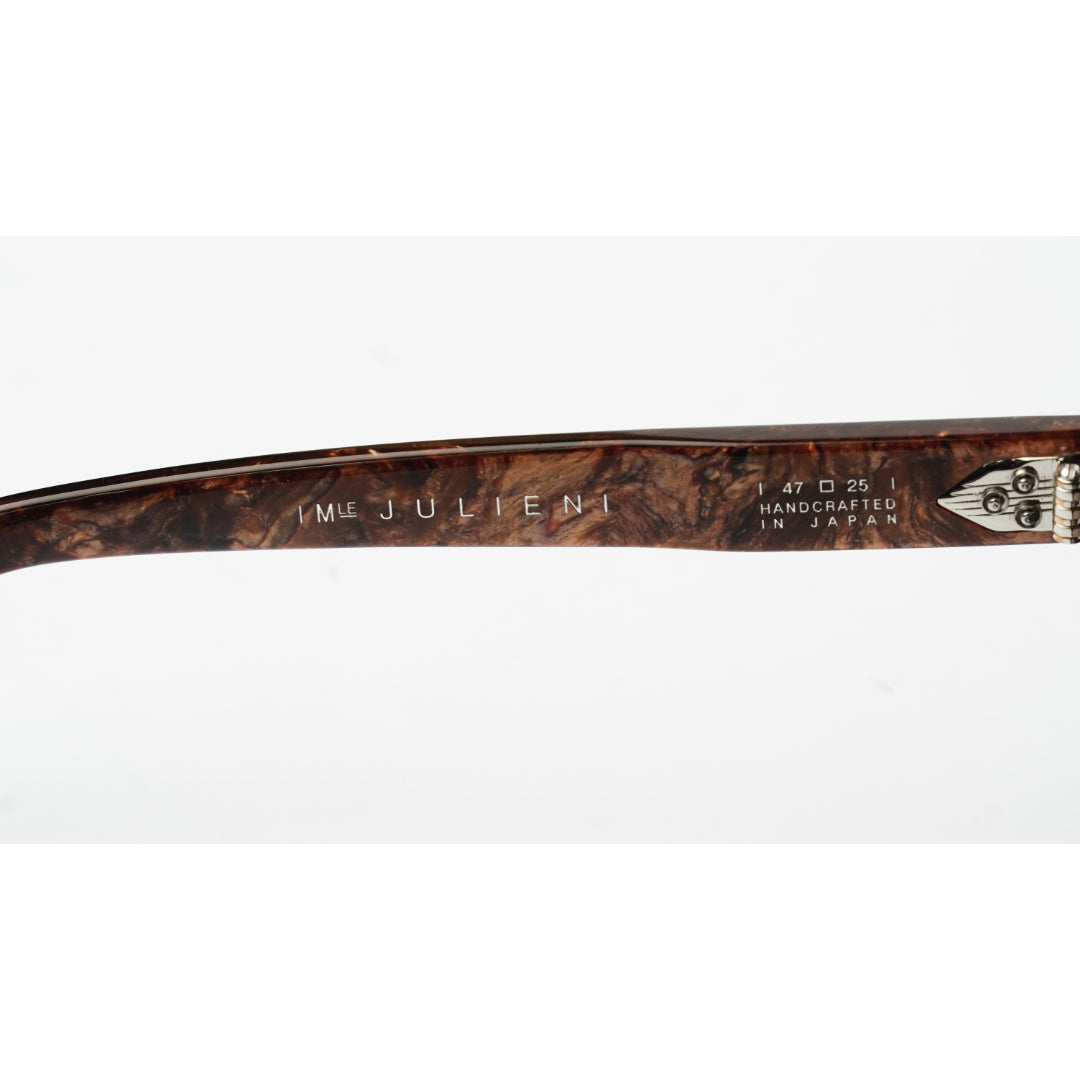 Close-up of a single eyeglass arm showing the inner temple with engraved text reading 'IME JULIEN' and '1 47 D 25 HANDCRAFTED IN JAPAN' on a white background.