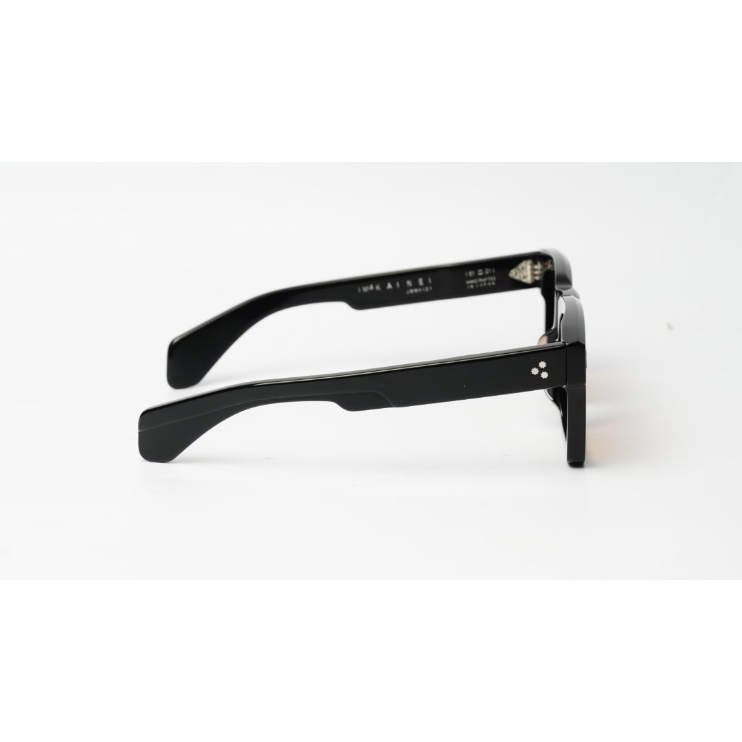 Black acetate square-frame sunglasses with a small silver-toned logo on the temple, shown from a side profile on a white background.